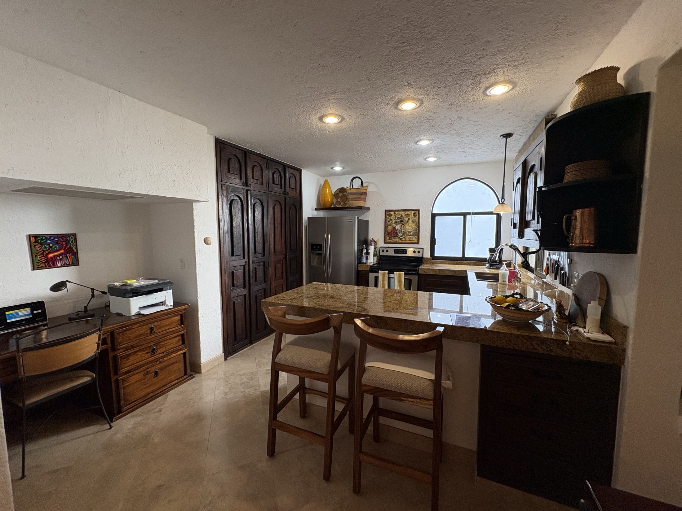 Kitchen with granite breakfast bar and stainless steel appliances