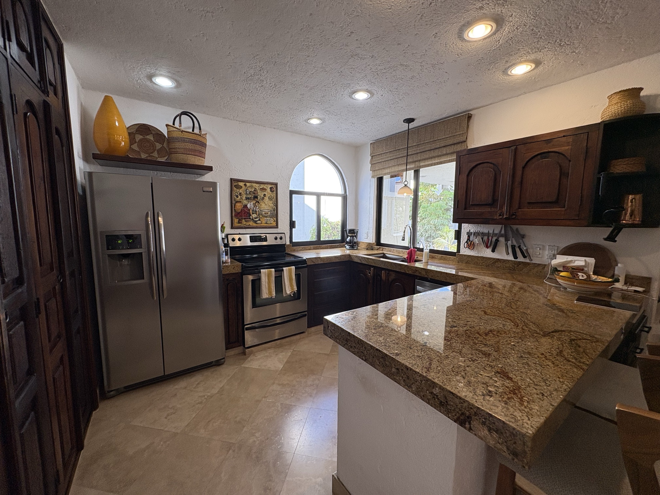 Kitchen workspace with granite counters and cabinetry
